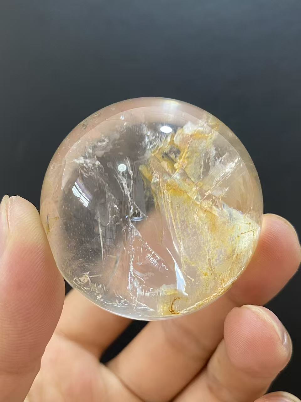 Polished Natural Clear Quartz Sphere Featuring Internal Yellow Hematoid Flower Inclusions for Home Display