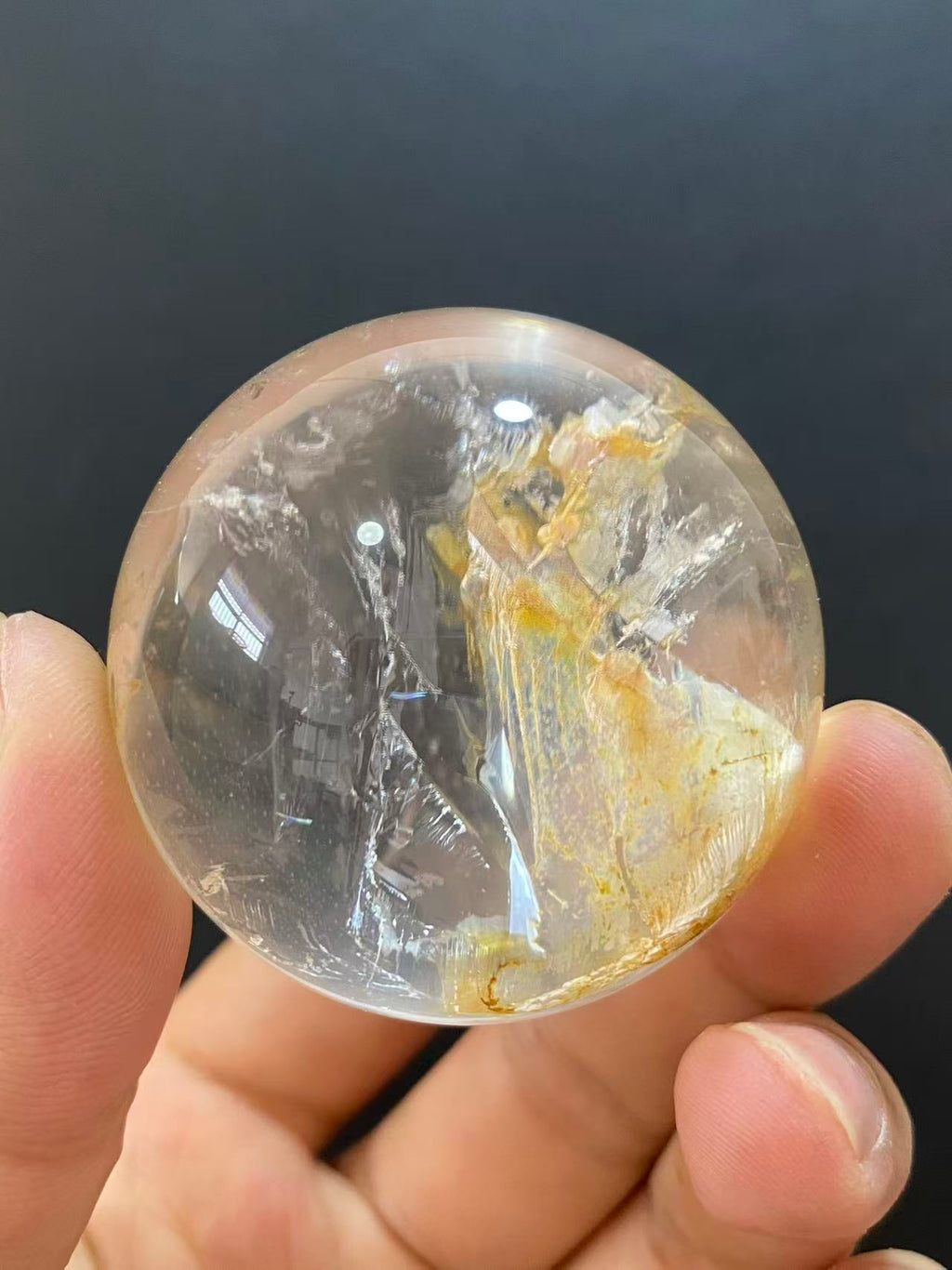 Polished Natural Clear Quartz Sphere Featuring Internal Yellow Hematoid Flower Inclusions for Home Display