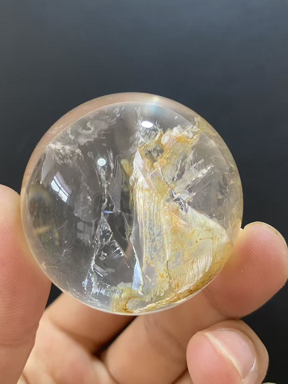 Polished Natural Clear Quartz Sphere Featuring Internal Yellow Hematoid Flower Inclusions for Home Display