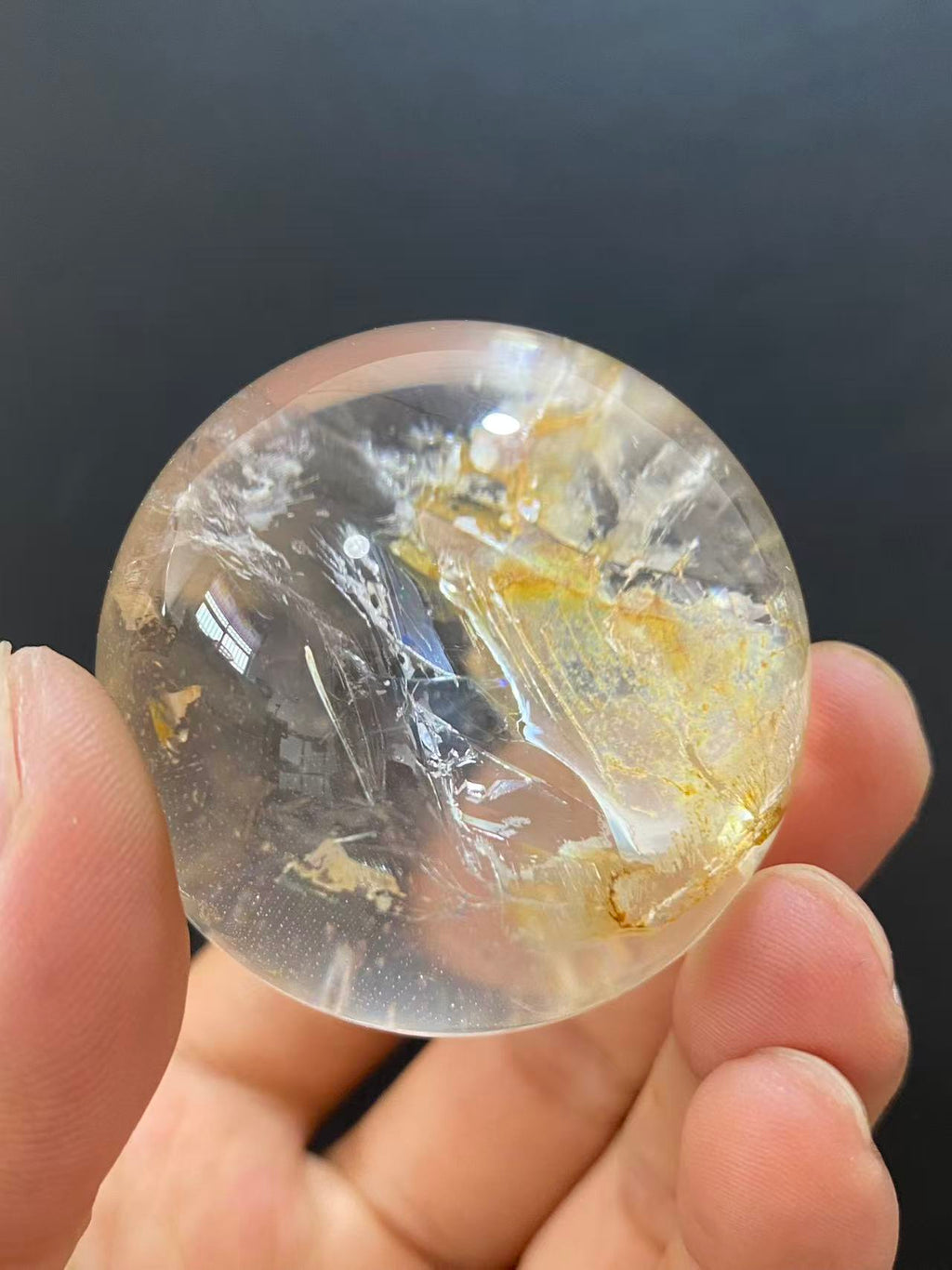 Polished Natural Clear Quartz Sphere Featuring Internal Yellow Hematoid Flower Inclusions for Home Display