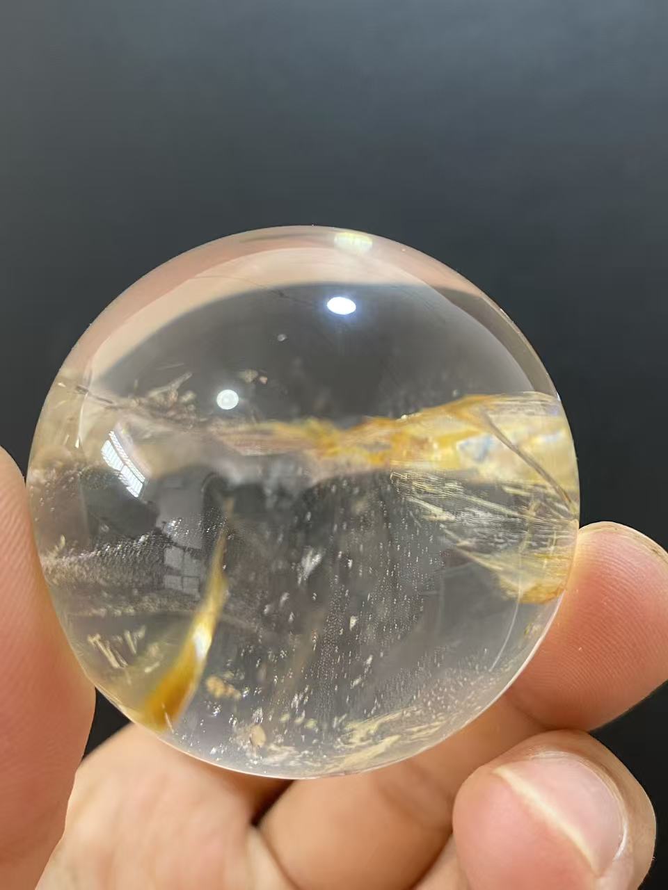 Polished Natural Clear Quartz Sphere Featuring Internal Yellow Hematoid Flower Inclusions for Home Display
