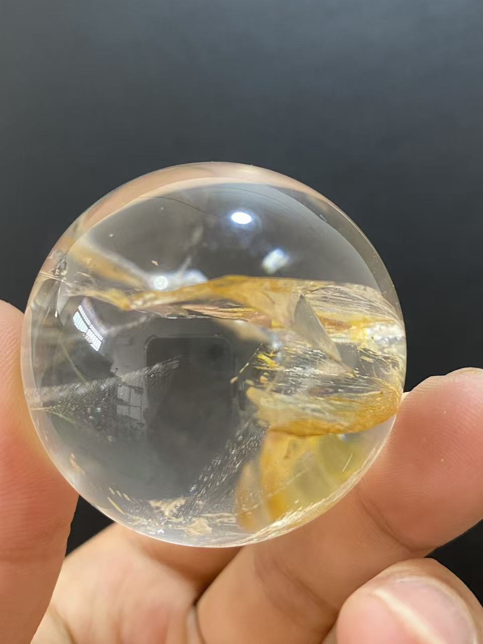 Polished Natural Clear Quartz Sphere Featuring Internal Yellow Hematoid Flower Inclusions for Home Display
