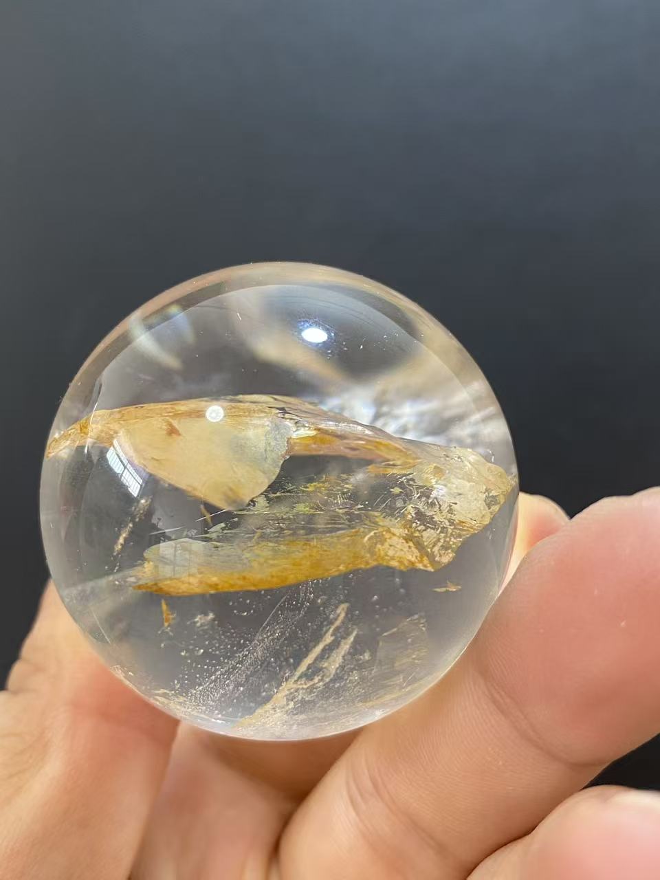 Polished Natural Clear Quartz Sphere Featuring Internal Yellow Hematoid Flower Inclusions for Home Display