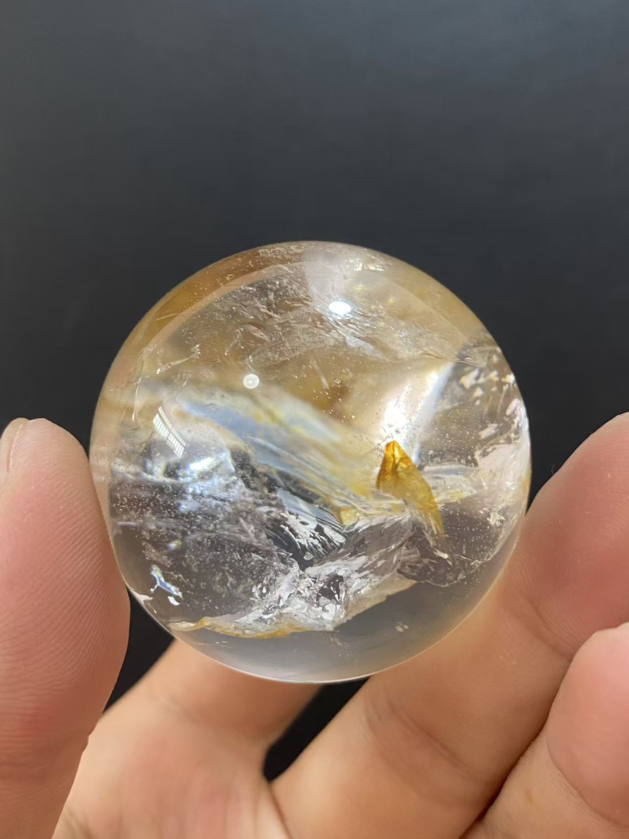 Polished Natural Clear Quartz Sphere Featuring Internal Yellow Hematoid Flower Inclusions for Home Display