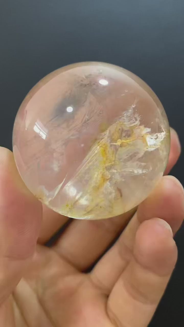 Polished Natural Clear Quartz Sphere Featuring Internal Yellow Hematoid Flower Inclusions for Home Display